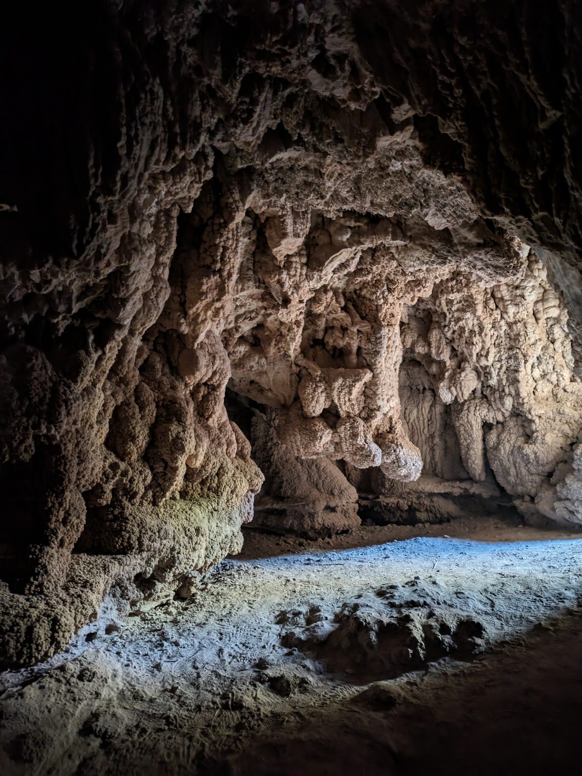 Inside one of the caves at Rifle Falls, the walls covered in knobby rock formations