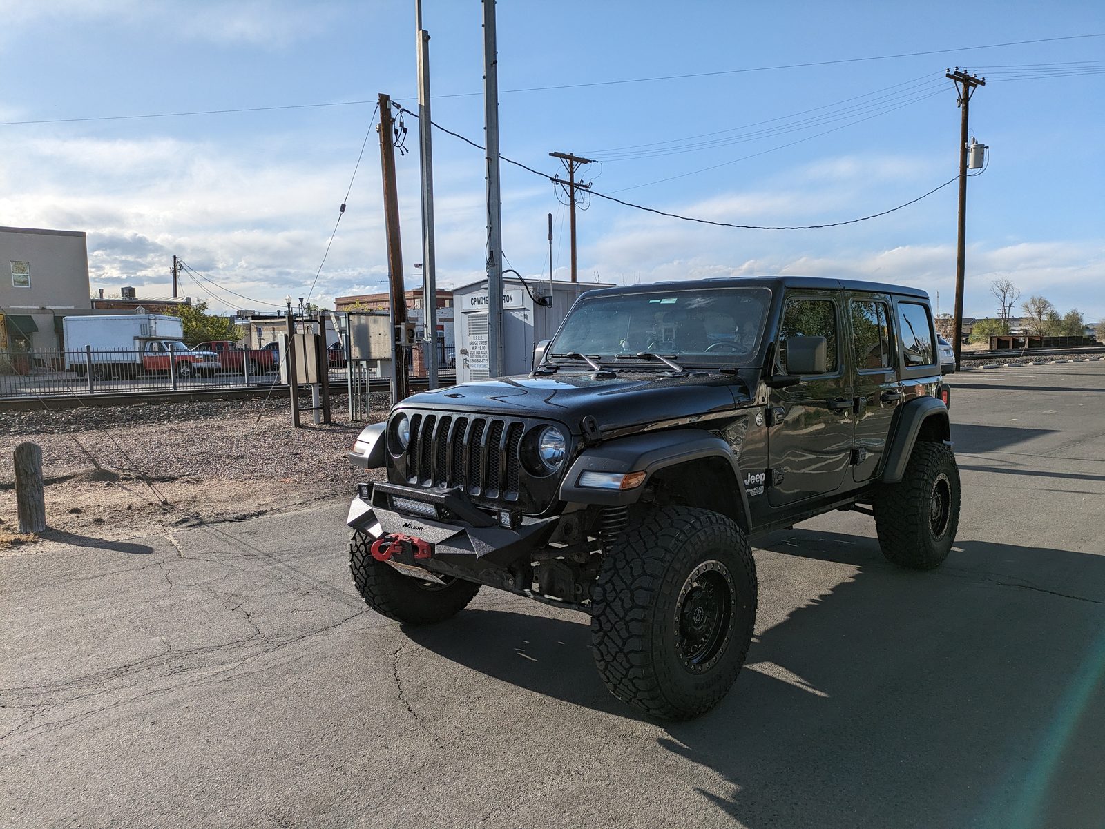 Sucia head-on from the driver's side, the steel bumper, light bar and red winch hook up front